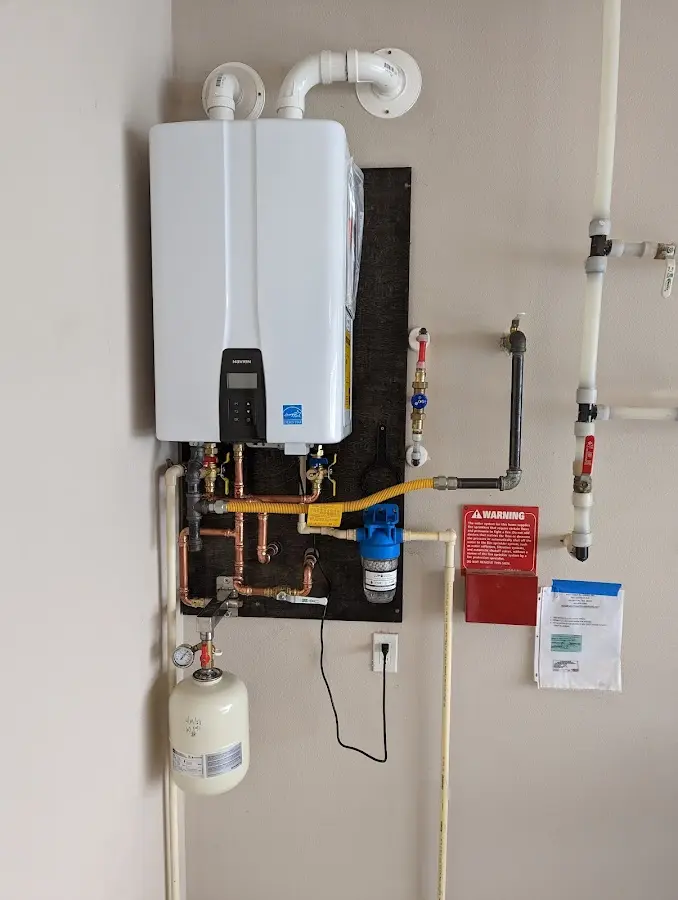 Professional plumber installing copper piping in a Kailua home